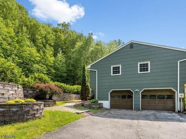 16 Seneca Trl, Randolph Twp, NJ 07869 - view of side of home featuring driveway and an attached garage