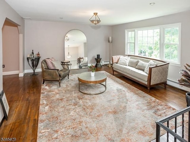 16 Seneca Trl, Randolph Twp, NJ 07869 - living area featuring arched walkways, a baseboard heating unit, and wood finished floors