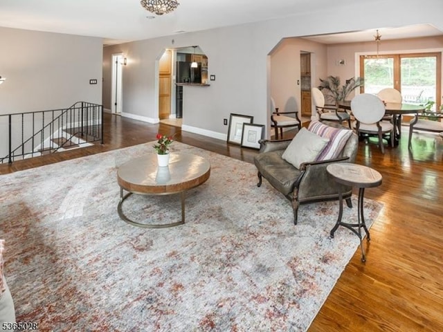 16 Seneca Trl, Randolph Twp, NJ 07869 - living area with arched walkways, wood finished floors, and a chandelier