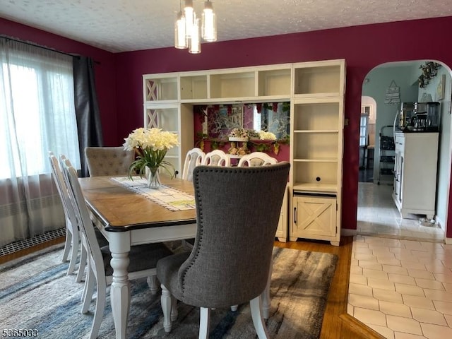 355 Manchester Ave, North Haledon Boro, NJ 07508 - dining space featuring a textured ceiling, arched walkways, and tile patterned floors