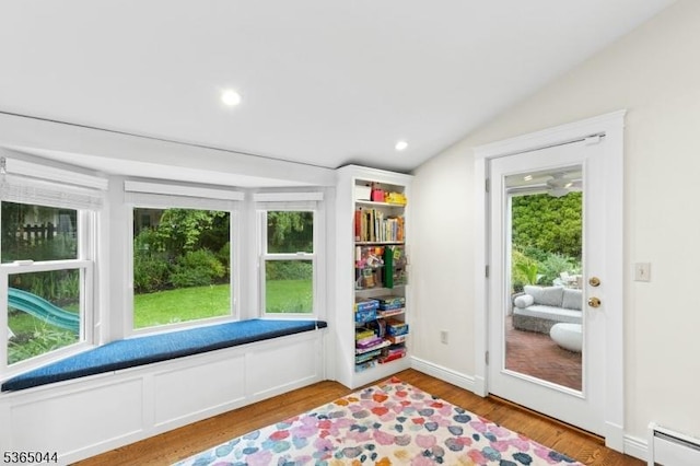 849 Bradford Ave, Westfield Town, NJ 07090 - living area with a baseboard heating unit, vaulted ceiling, wood finished floors, and recessed lighting