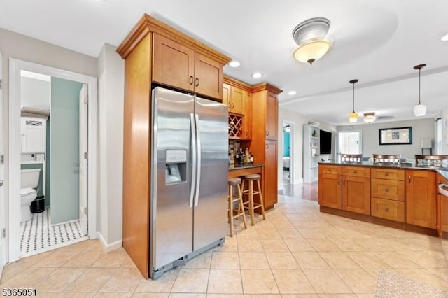 268 Warburton Ave, Hawthorne Boro, NJ 07506 - kitchen with stainless steel refrigerator with ice dispenser, dark countertops, brown cabinets, light tile patterned floors, and recessed lighting