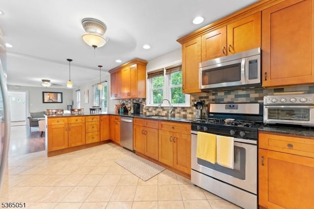 268 Warburton Ave, Hawthorne Boro, NJ 07506 - kitchen with stainless steel appliances, a peninsula, decorative backsplash, dark countertops, and brown cabinetry
