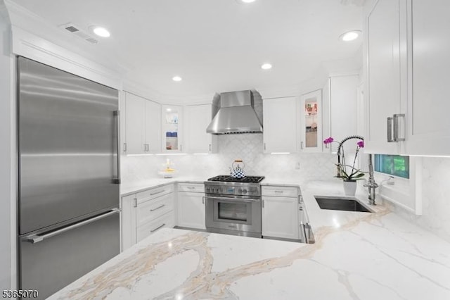 3310 Round Hill Rd, Branchburg Twp, NJ 08876 - kitchen featuring premium appliances, wall chimney exhaust hood, white cabinetry, glass insert cabinets, and recessed lighting