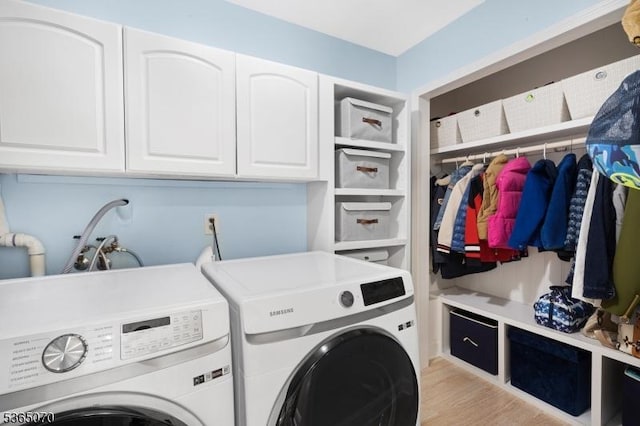 3310 Round Hill Rd, Branchburg Twp, NJ 08876 - laundry room featuring independent washer and dryer, cabinet space, and light wood-type flooring