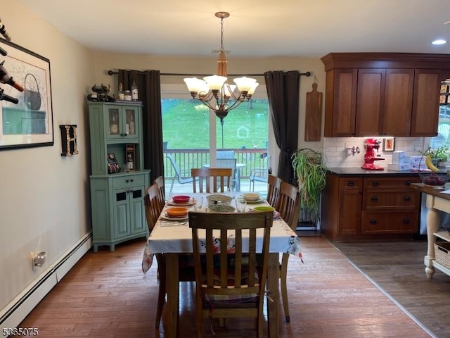 126 Hilltop Trl, Sparta Twp, NJ 07871 - dining area with a baseboard heating unit, a chandelier, wood finished floors, and recessed lighting
