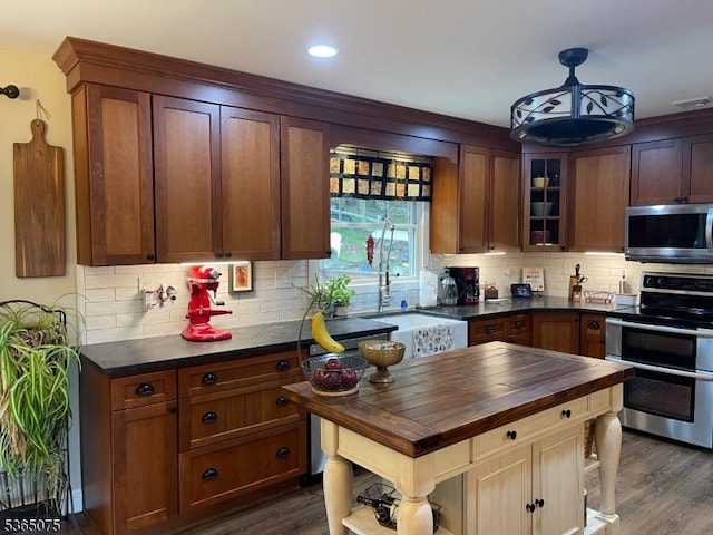 126 Hilltop Trl, Sparta Twp, NJ 07871 - kitchen featuring appliances with stainless steel finishes, butcher block countertops, dark wood finished floors, tasteful backsplash, and recessed lighting