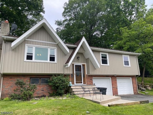126 Hilltop Trl, Sparta Twp, NJ 07871 - split foyer home with brick siding, a garage, asphalt driveway, a front yard, and board and batten siding
