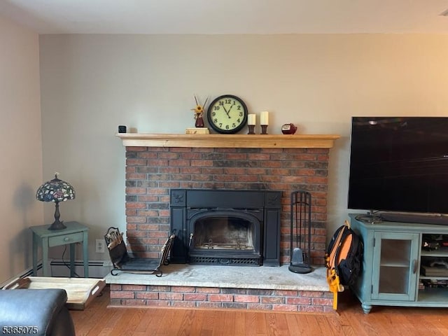 126 Hilltop Trl, Sparta Twp, NJ 07871 - detailed view of wood finished floors, a baseboard radiator, and a fireplace