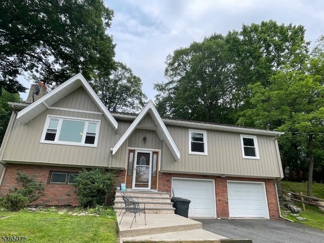 126 Hilltop Trl, Sparta Twp, NJ 07871 - split foyer home featuring driveway, a garage, brick siding, and a chimney