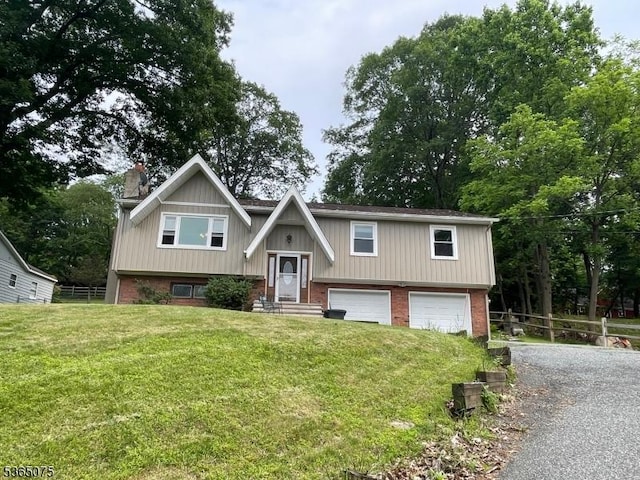 126 Hilltop Trl, Sparta Twp, NJ 07871 - bi-level home with an attached garage, a chimney, gravel driveway, and brick siding