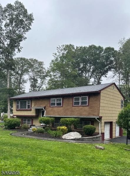 25 Lockwood Ave, Byram Twp, NJ 07874 - raised ranch with an attached garage, a front yard, and asphalt driveway