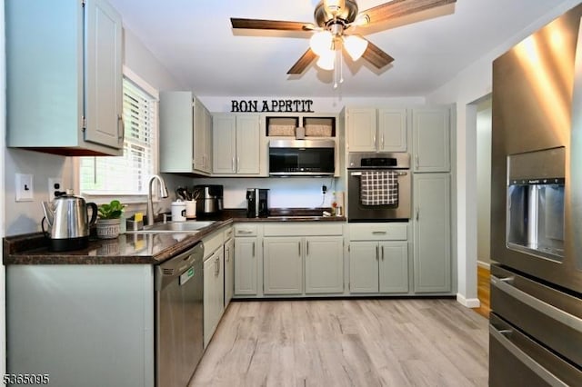 25 Lockwood Ave, Byram Twp, NJ 07874 - kitchen with appliances with stainless steel finishes, dark countertops, light wood-style floors, and a ceiling fan