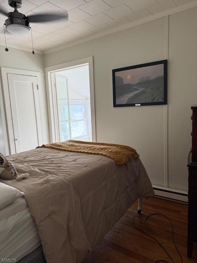 142 Lakeside Dr, Liberty Twp, NJ 07823 - bedroom featuring crown molding, wood finished floors, a baseboard radiator, and a ceiling fan