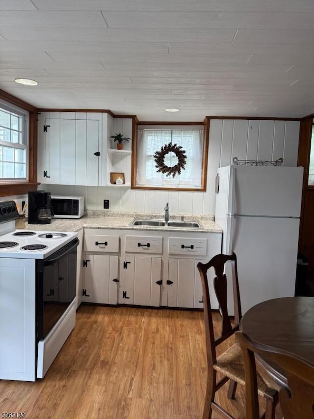 142 Lakeside Dr, Liberty Twp, NJ 07823 - kitchen featuring white appliances, light wood-style floors, white cabinets, and open shelves
