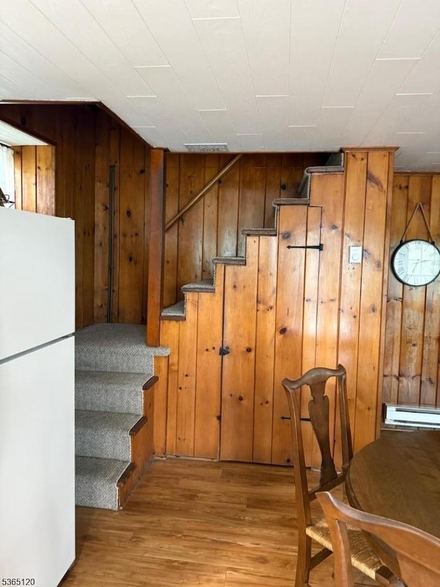 142 Lakeside Dr, Liberty Twp, NJ 07823 - staircase with wood walls, wood finished floors, and baseboard heating