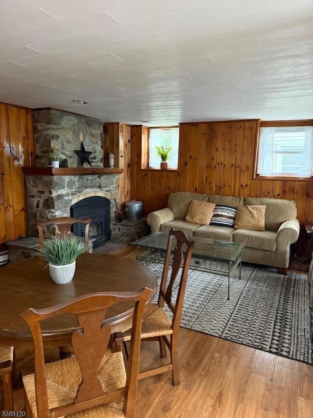 142 Lakeside Dr, Liberty Twp, NJ 07823 - living room featuring wooden walls, wood finished floors, and a fireplace