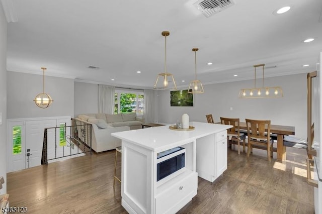 26 Robert St, Mount Olive Twp, NJ 07836 - kitchen with white cabinetry, a center island, dark wood finished floors, ornamental molding, and hanging light fixtures