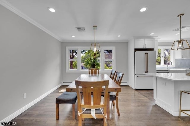 26 Robert St, Mount Olive Twp, NJ 07836 - dining area with crown molding, plenty of natural light, recessed lighting, a baseboard radiator, and dark wood-type flooring