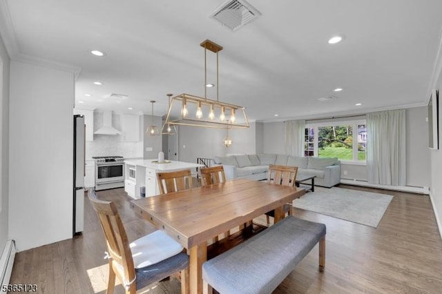 26 Robert St, Mount Olive Twp, NJ 07836 - dining space with a baseboard radiator, ornamental molding, dark wood-type flooring, and recessed lighting