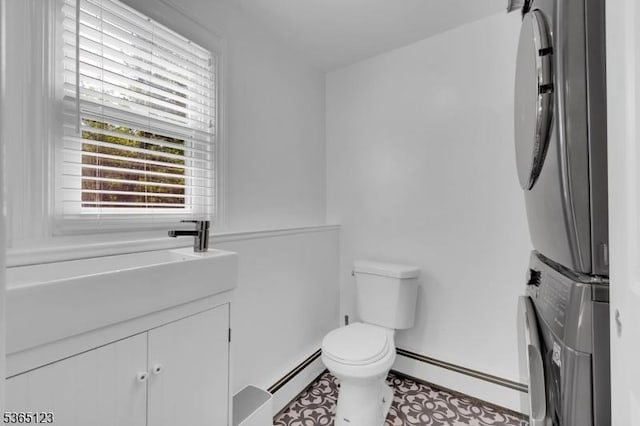 26 Robert St, Mount Olive Twp, NJ 07836 - bathroom with stacked washer / drying machine, baseboard heating, and vanity