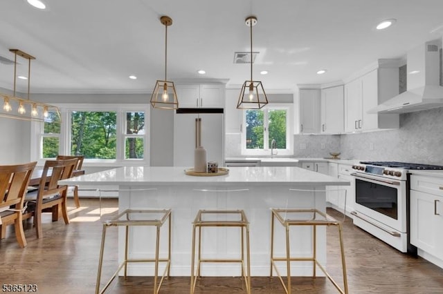 26 Robert St, Mount Olive Twp, NJ 07836 - kitchen featuring white range with gas stovetop, wall chimney exhaust hood, high quality fridge, a center island, and tasteful backsplash