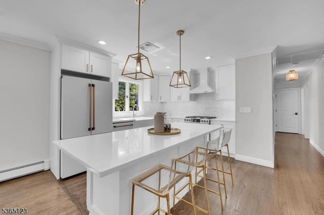 26 Robert St, Mount Olive Twp, NJ 07836 - kitchen with custom range hood, high end refrigerator, recessed lighting, white cabinetry, and light countertops