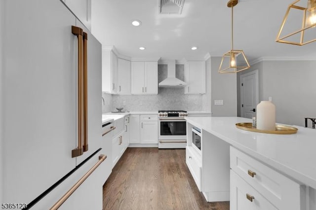 26 Robert St, Mount Olive Twp, NJ 07836 - kitchen with white fridge, high end stainless steel range, wall chimney range hood, decorative backsplash, and light countertops