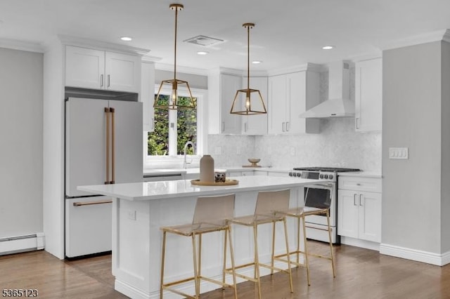 26 Robert St, Mount Olive Twp, NJ 07836 - kitchen featuring wall chimney exhaust hood, stainless steel gas range, high end white refrigerator, a center island, and light countertops