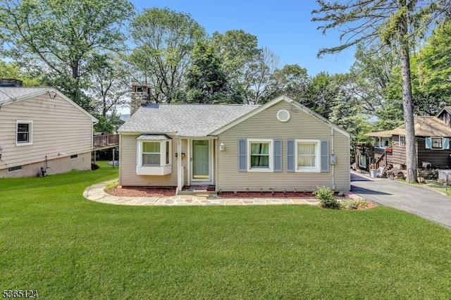 76 Hillside Rd, Sparta Twp, NJ 07871 - view of front of house with a chimney, a front lawn, asphalt driveway, and roof with shingles