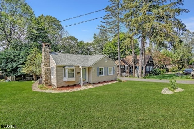 76 Hillside Rd, Sparta Twp, NJ 07871 - view of front of home featuring a front yard, a chimney, and roof with shingles