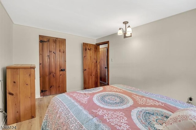 76 Hillside Rd, Sparta Twp, NJ 07871 - bedroom with light wood-type flooring and a chandelier