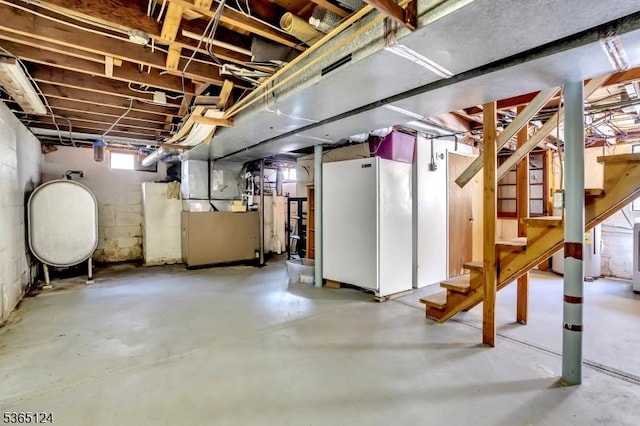 76 Hillside Rd, Sparta Twp, NJ 07871 - below grade area featuring stairway, heating unit, freestanding refrigerator, and oil tank