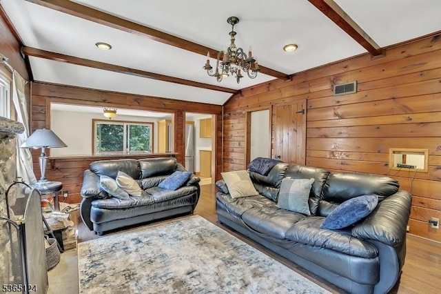 76 Hillside Rd, Sparta Twp, NJ 07871 - living room with wood walls, a chandelier, and wood finished floors