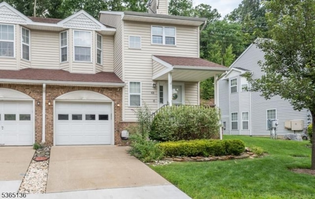 63 Rockcreek Ter, Riverdale Boro, NJ 07457 - townhome / multi-family property with a front lawn, concrete driveway, an attached garage, brick siding, and a chimney