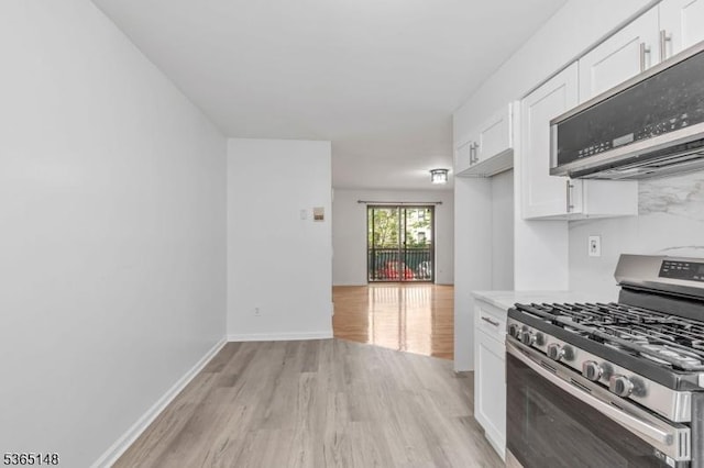 120 Westfield Ave Unit 12, Elizabeth City, NJ 07208 - kitchen with appliances with stainless steel finishes, light wood-style floors, and white cabinetry
