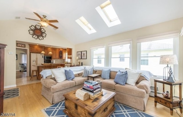 425 Broadway, Pompton Lakes Boro, NJ 07442 - living room with high vaulted ceiling, light wood finished floors, a skylight, baseboard heating, and a ceiling fan