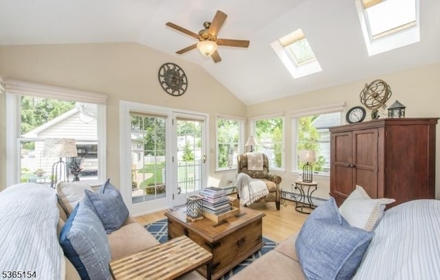 425 Broadway, Pompton Lakes Boro, NJ 07442 - living room featuring a skylight, lofted ceiling, light wood finished floors, a ceiling fan, and a baseboard radiator