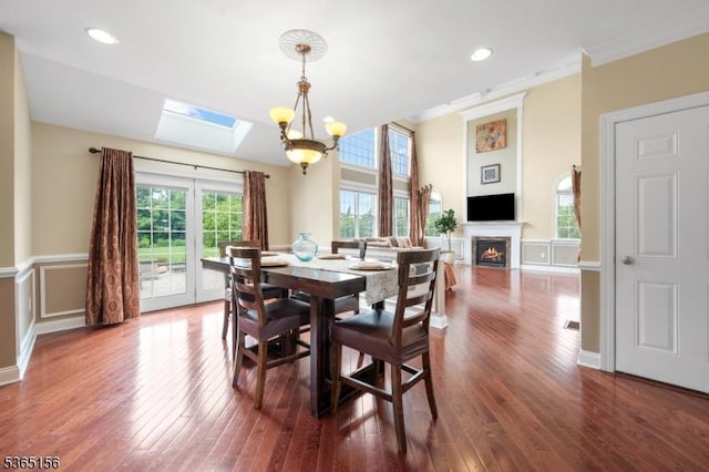 6 Cope Ct, Hillsborough Twp, NJ 08844 - dining room featuring a skylight, wood-type flooring, a lit fireplace, ornamental molding, and recessed lighting