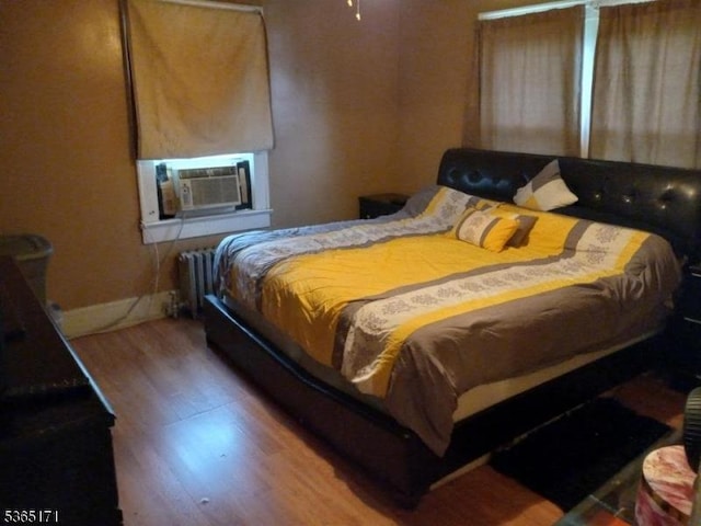 1368 E 2nd St, Plainfield City, NJ 07062 - bedroom with radiator, cooling unit, and wood finished floors