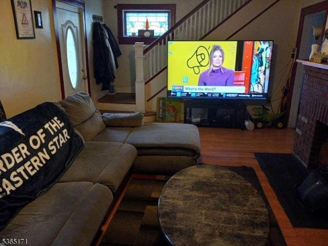 1368 E 2nd St, Plainfield City, NJ 07062 - living room featuring stairway, wood finished floors, and a brick fireplace