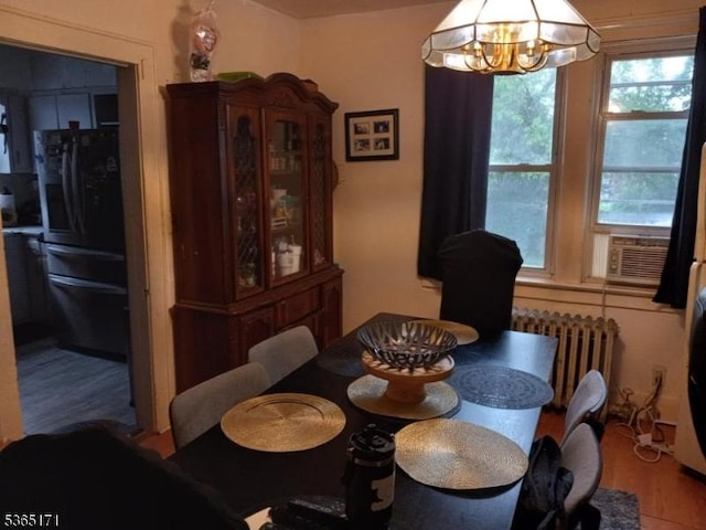 1368 E 2nd St, Plainfield City, NJ 07062 - dining space featuring wood finished floors, radiator heating unit, and a chandelier