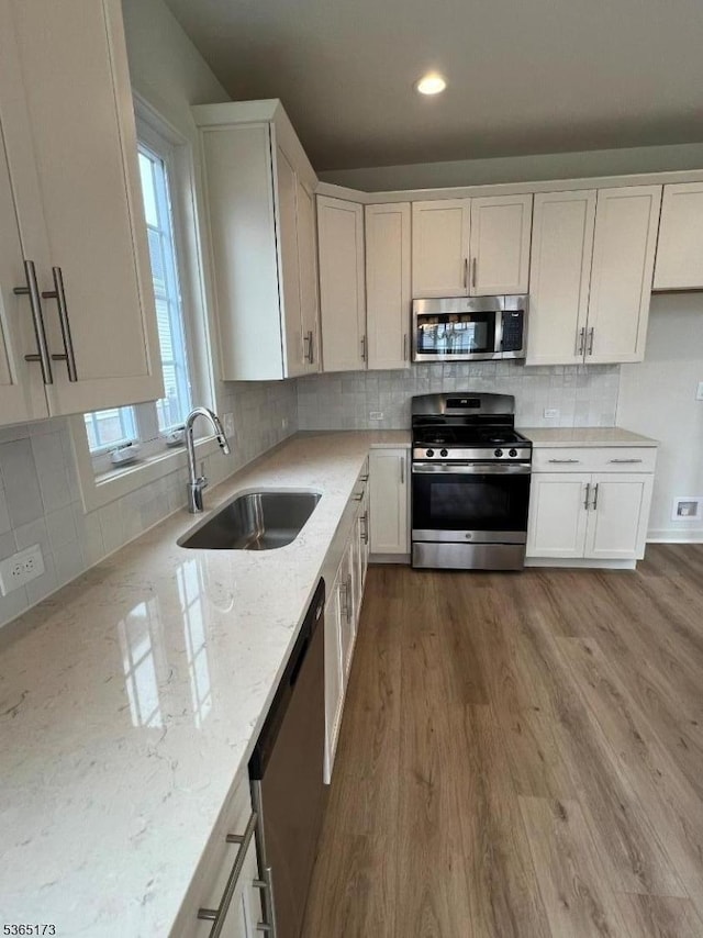 77 Norton Rd, Hillsborough Twp, NJ 08844 - kitchen with stainless steel appliances, light stone counters, white cabinetry, wood finished floors, and recessed lighting