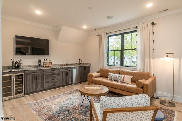 2 County Line Rd, Mendham Boro, NJ 07945 - living area featuring wine cooler, bar with sink, crown molding, light wood finished floors, and recessed lighting