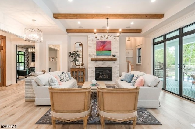 2 County Line Rd, Mendham Boro, NJ 07945 - living room featuring a chandelier, beamed ceiling, light wood-style flooring, and a fireplace