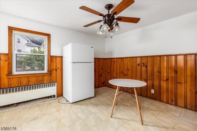 267 William St, Belleville Twp, NJ 07109 - unfurnished dining area featuring radiator, wainscoting, wood walls, and ceiling fan