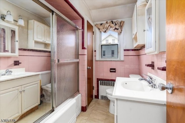 267 William St, Belleville Twp, NJ 07109 - bathroom featuring tile walls, radiator, vanity, enclosed tub / shower combo, and tile patterned flooring