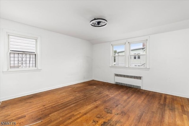267 William St, Belleville Twp, NJ 07109 - empty room with radiator heating unit and wood finished floors