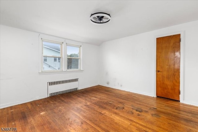 267 William St, Belleville Twp, NJ 07109 - empty room featuring radiator heating unit and wood-type flooring