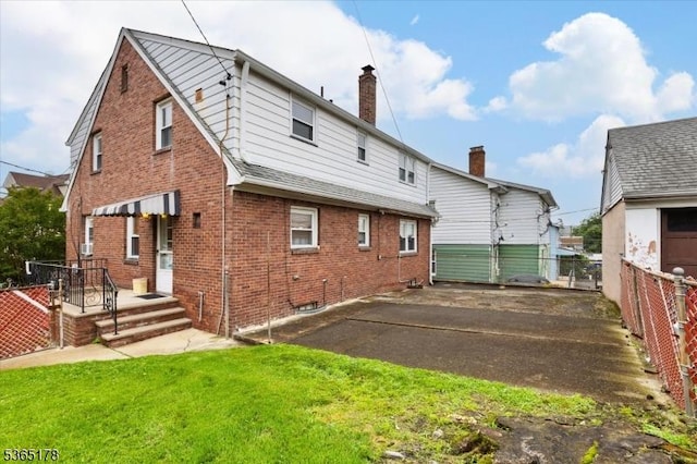 267 William St, Belleville Twp, NJ 07109 - back of house featuring brick siding, asphalt driveway, and a chimney